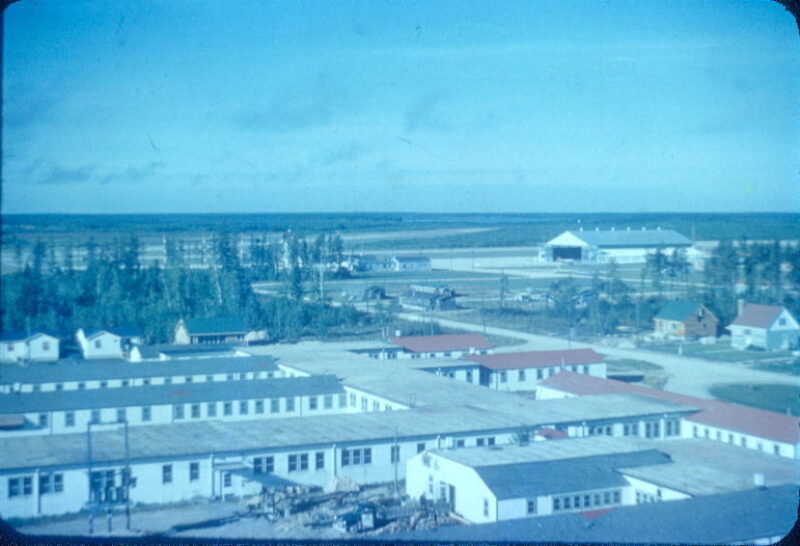 An aerial view of long, single-storey buildings. Smaller detatched buildings stand next to the long buildings.