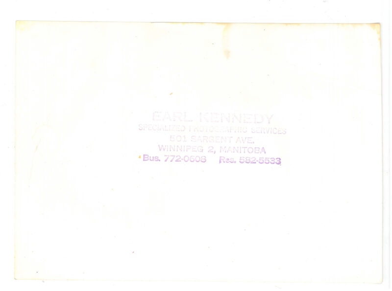Verso: Photographer's stamp: "Earl Kennedy Specialized Photographic Services 501 Sargent Ave Winnipeg 2, Manitoba Bus. 772-0608 Res. 582-5533"