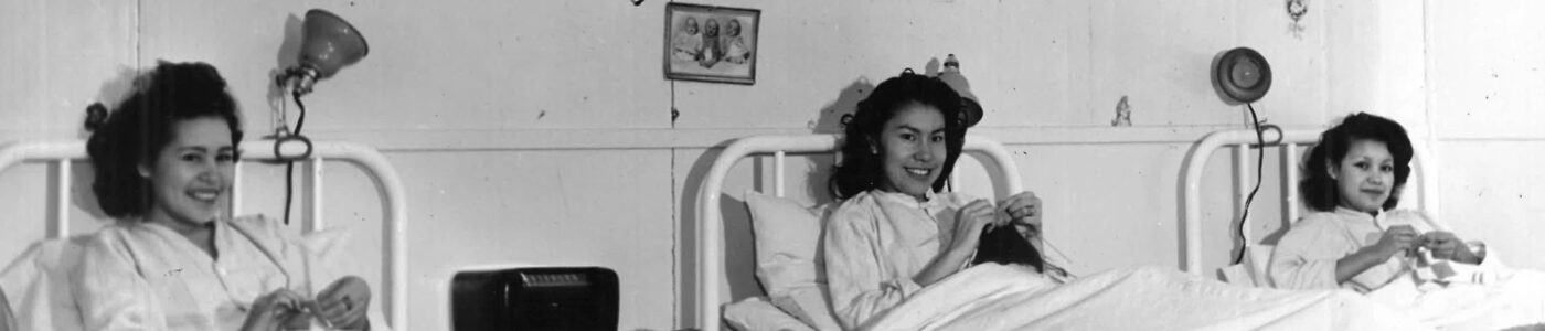 Three women in hospital beds knitting