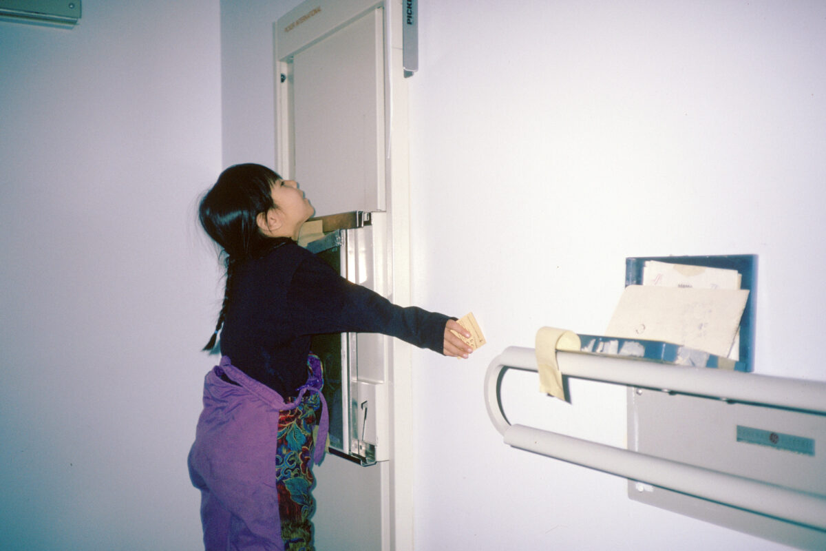 A child pressing her chest against an x-ray plate with her arms spread to the side.