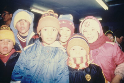 Six children in winter gear gather for the camera.