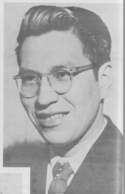 A portrait of a man with glasses.