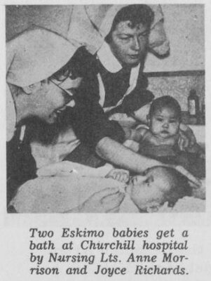 A nurse gives a baby a bath while another nurse swaddles another baby.