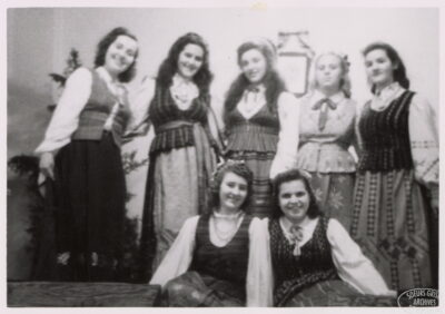 Seven young women pose as a group.