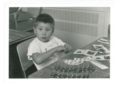 Boy with Manitoba Lung Association Christmas seal stamps
